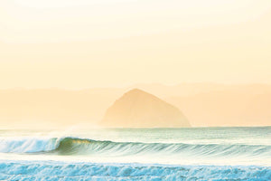 This photograph was taken from the beach in Cayucos, California with the iconic Morro Rock in the background. The offshore winds and luminous colors highlighting the wave just right.